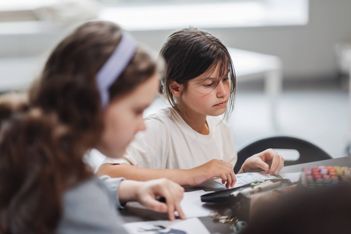A camper deep in focus during an art studio session, Exupery Camp