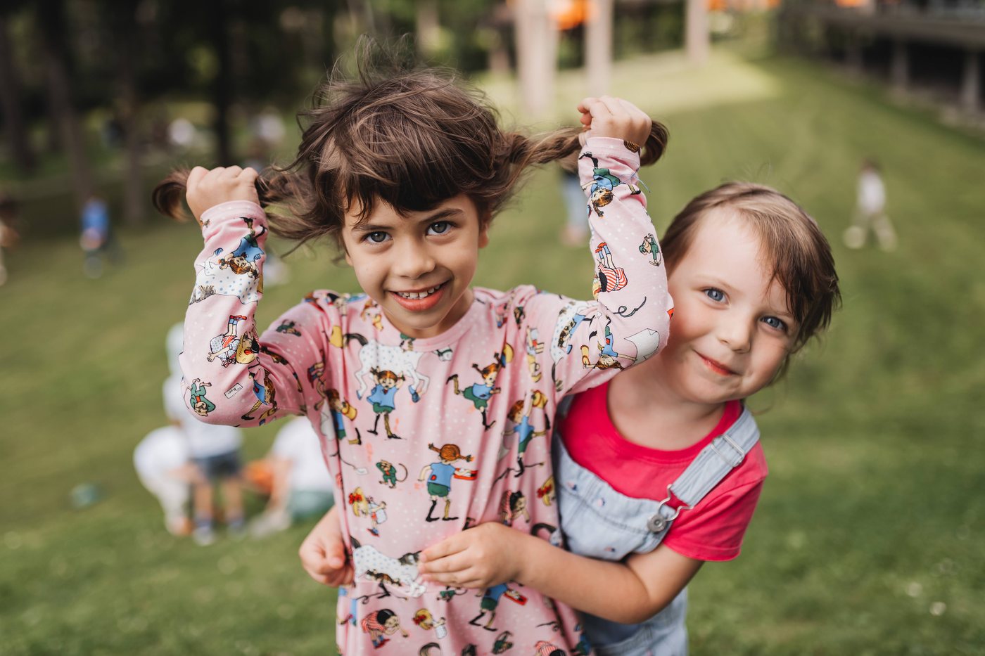 Two campers playing together outdoors on the grass — Living Map week