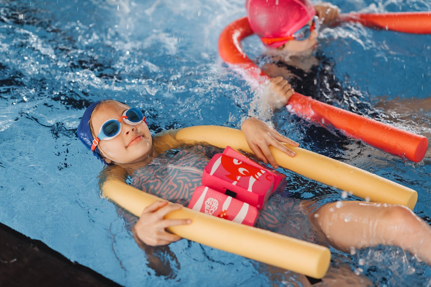 Campers in a swimming lesson with pool noodles — Sound and Stage week