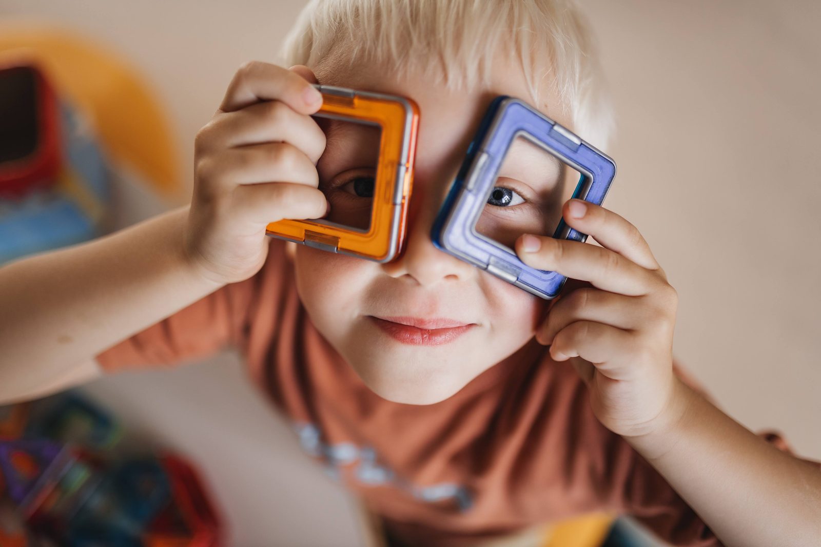 A camper looking through colourful magnetic frames like a pair of glasses at MetaMind, EIS Campus