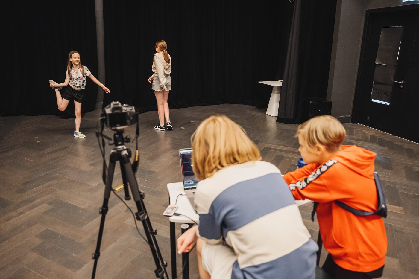 A camper directing a shot with a camera on a tripod, Cinema Studio, Exupery Camp