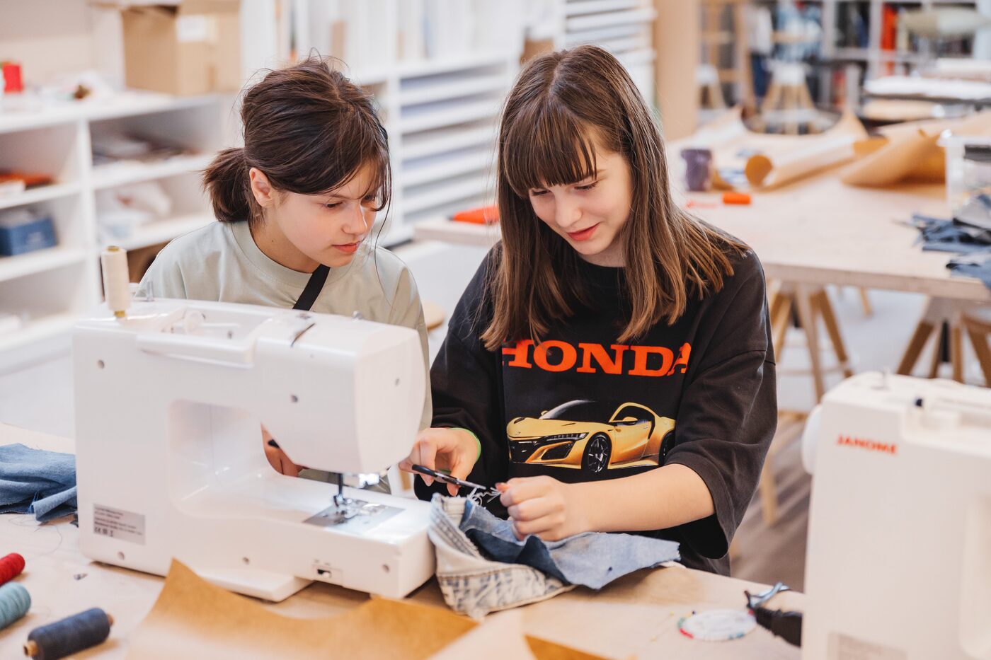 Campers working at sewing machines, Fashion Studio, Exupery Camp